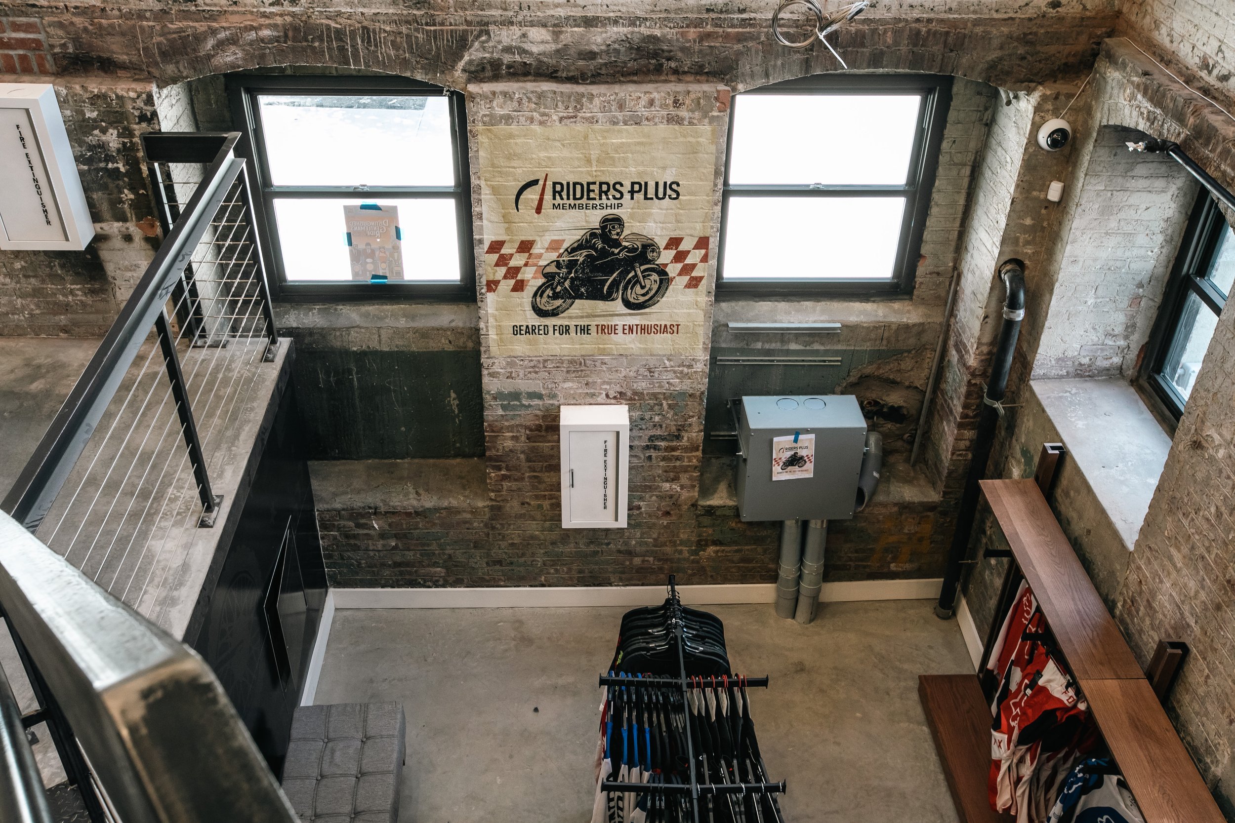 Riders Plus membership poster installed in the store window